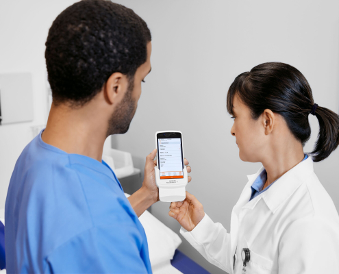 Healthcare professionals reviewing test results on Atellica DCA Analyzer